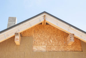 Attic insulation. New house wall facade insulation against blue sky. Roof insulation detail. Building insulation, added to buildings for comfort energy saving and energy efficiency.